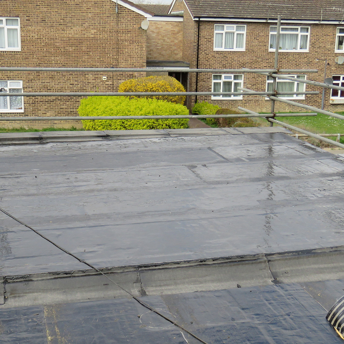 Durable GRP flat roofing system being applied to a home extension